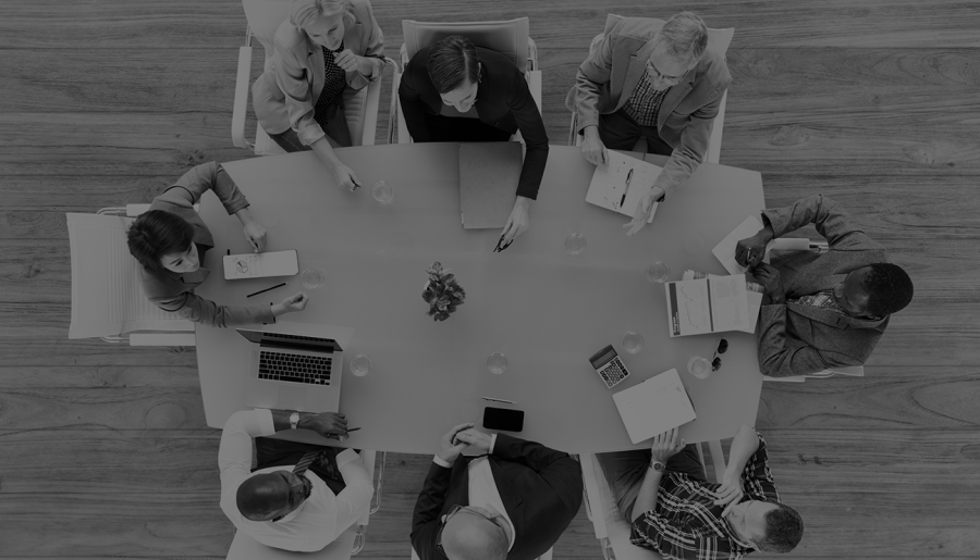 Group of business people at a conference table stock photo